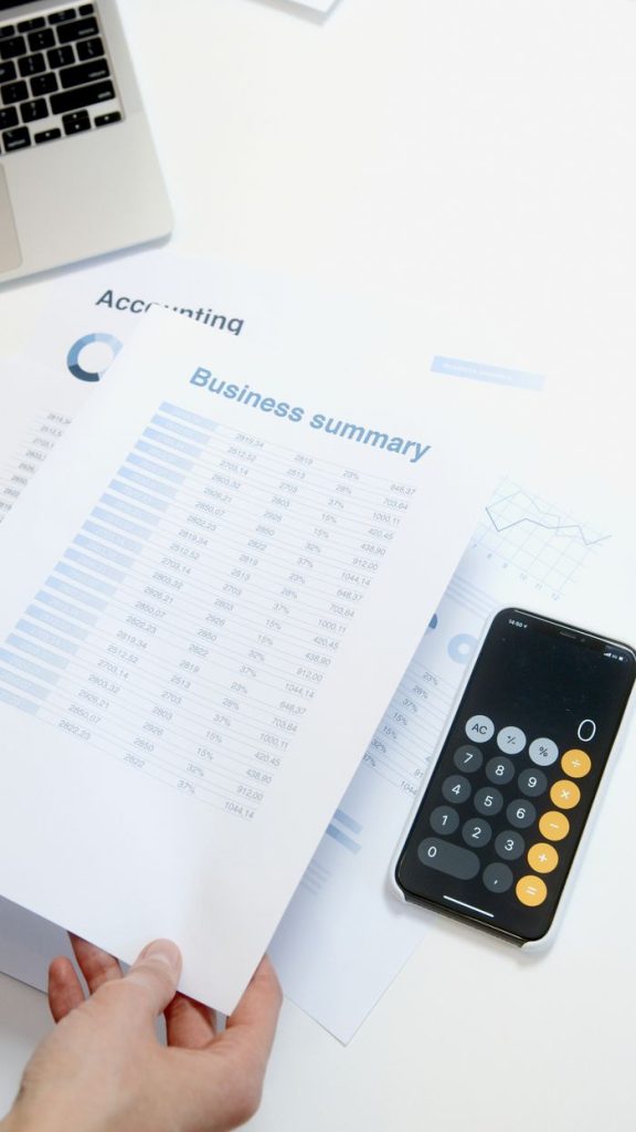 Crafting Captivating Headlines: Your awesome post title goes here Business summary sheet with a calculator on a desk for financial analysis.